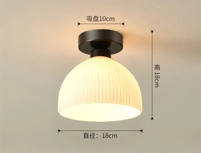 A warm glowing modern ribbed ceramic glass chandelier with off-white shade and matte black base for living room decorbites ceramic glass