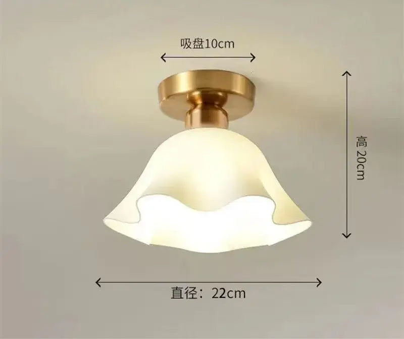 A warm-toned bell-shaped decorbites ceramic glass chandelier with brass ceiling mount for modern living room decor