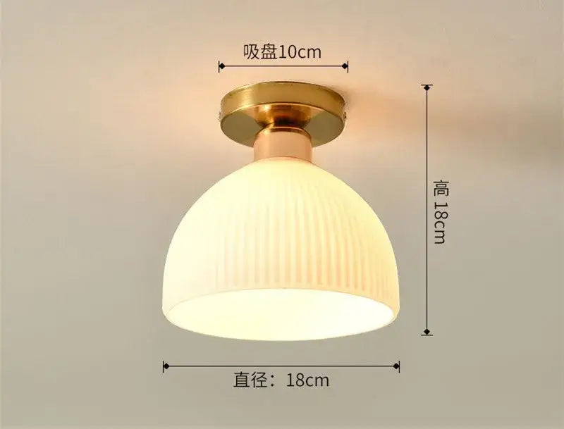 A cream-colored decorbites ceramic glass chandelier with vertical ridges and brass ceiling mount for living room decor