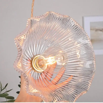 Modern ribbed clear glass pendant light with brass fixture and exposed filament bulb by decorbites clear glass