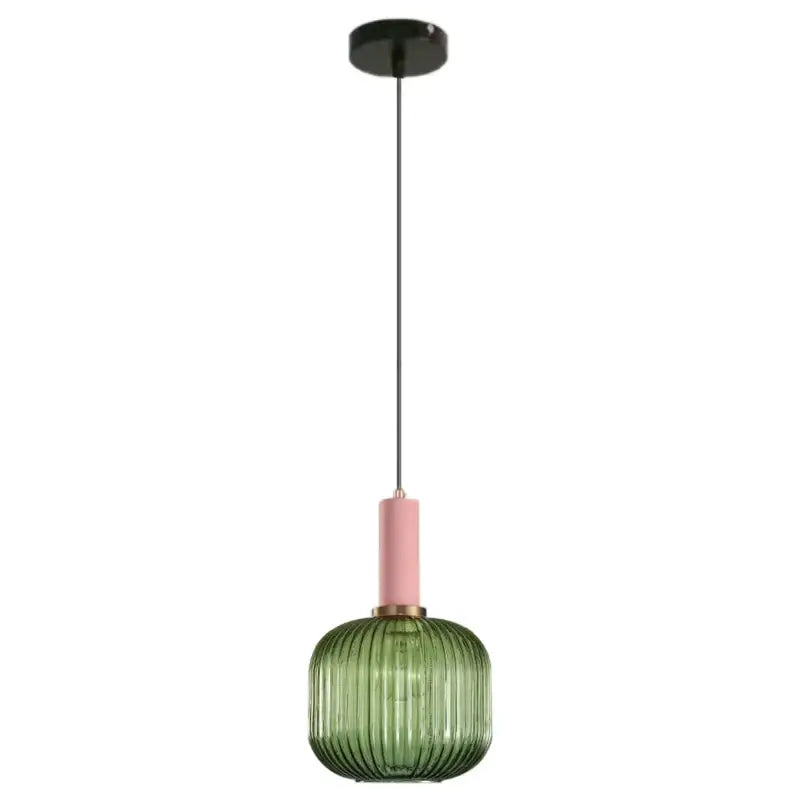 A modern decorbites green pumpkin pendant light with ribbed green pumpkin glass and pink accent for dining room decor