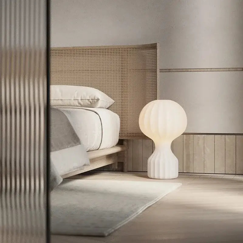 A sleek white ceramic table lamp with ribbed spherical shade and fluted base ideal for decorbites gatto silk table decor