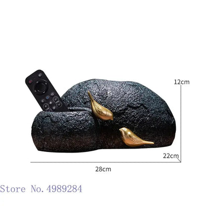 Black textured rock-shaped tv remote holder with two golden bird resin figurines for modern tissue box decorbites golden bird decor