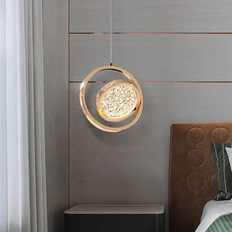 Modern gold-toned pendant light featuring a sparkling crystal center with acrylic led chandelier design for dining rooms