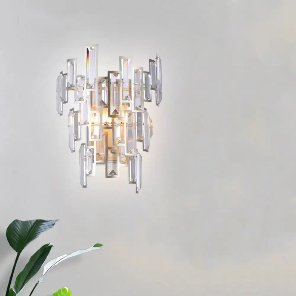 Modern rose gold wall lamp with asymmetrical clear crystal rectangles and warm center light for dining room use