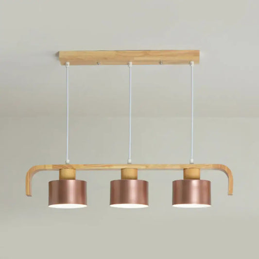 Modern rose gold drum island chandelier with copper-finished pendant lights on light wood frame for dining table
