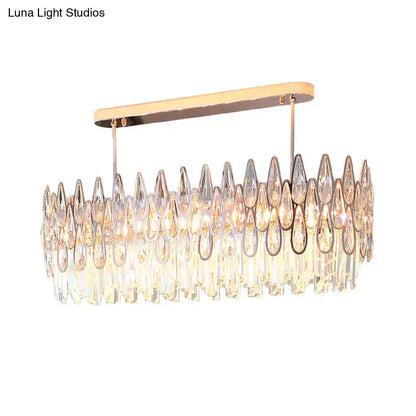 A modern rose gold island lighting chandelier with cascading clear and iridescent crystal tiers for kitchens