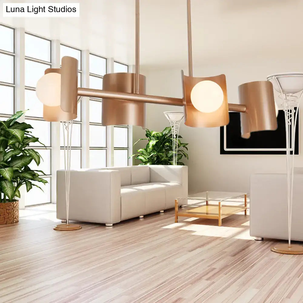 Modern rose gold pendant light with copper-toned cylindrical shades and spherical light fixture for dining room