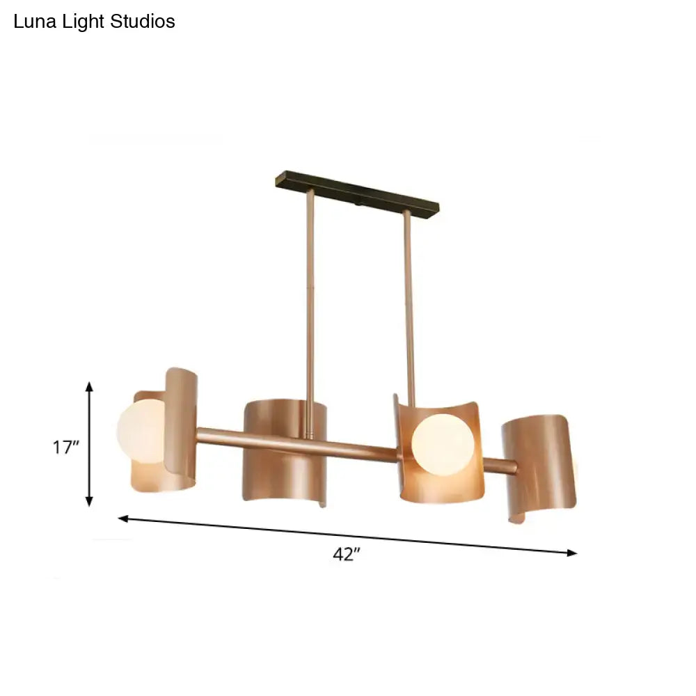 Modern rose gold pendant light featuring a copper-toned chandelier with four cylindrical shades and sleek horizontal bar design