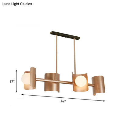 Modern rose gold pendant light featuring a copper-toned chandelier with four cylindrical shades and sleek horizontal bar design