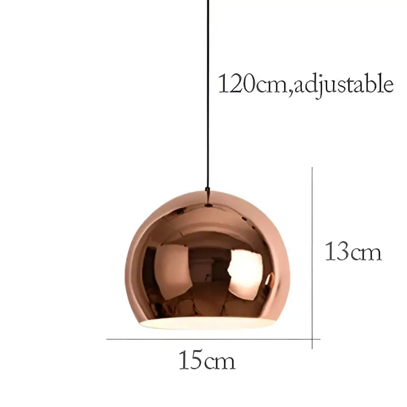 A sleek rose gold pendant light with a polished metallic dome design perfect for dining room decorbites rose gold decor