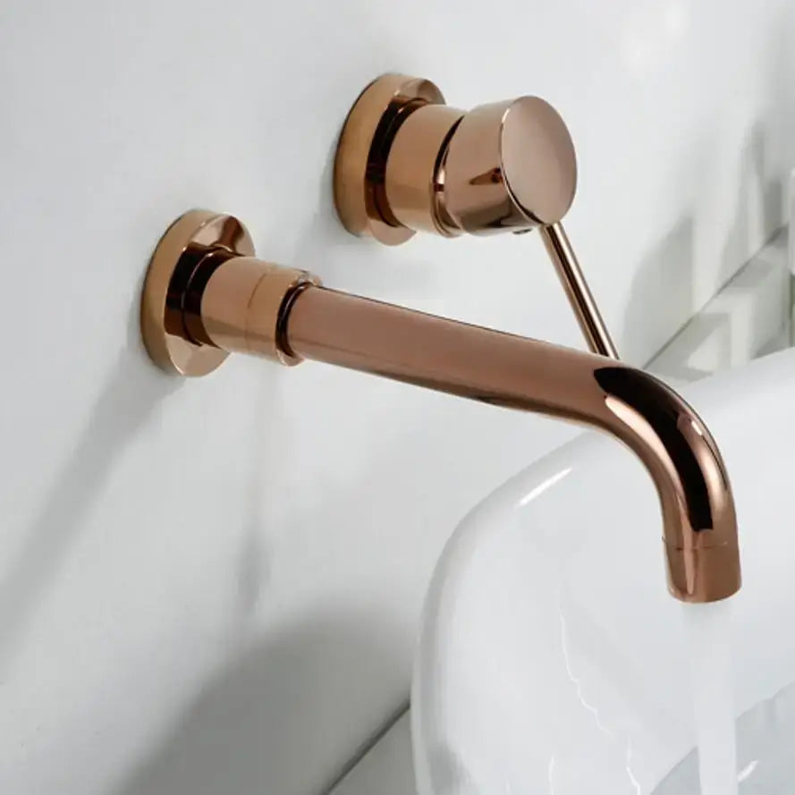 A modern rose gold wall mounted bathroom faucet with a sleek design cold water single-hole deck installation