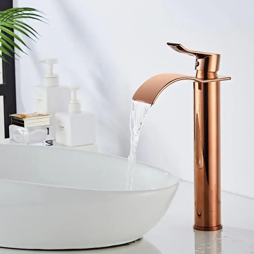 Modern rose gold single hole basin faucet with sleek waterfall design and durable housing material for bathroom use