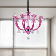 A vibrant rose red glass chandelier with crystal droplets and candle-style bulbs for living room decor