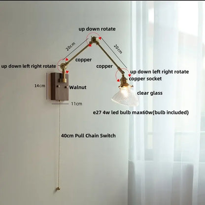 Adjustable copper wall light fixture with clear glass shade and walnut-finished mounting plate for modern stair lighting
