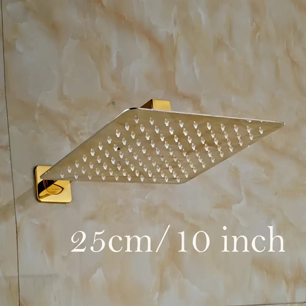 Modern square gold-finished shower head set with ultrathin design and grid of small nozzles for rainfall showering