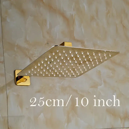 Modern square gold-finished shower head set with ultrathin design and grid of small nozzles for rainfall showering