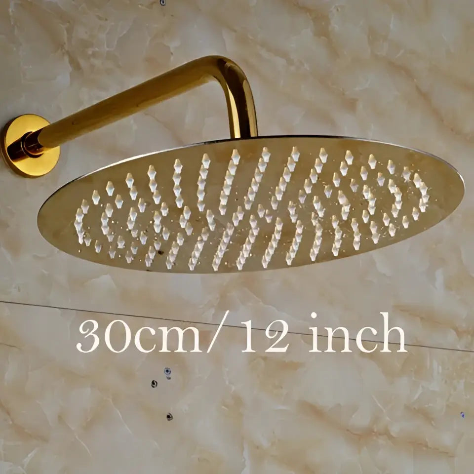 Modern round gold ultrathin rainfall shower head set with a sleek metallic finish and multiple water jets in an oval pattern