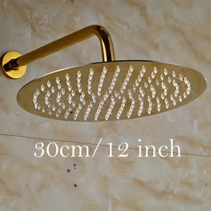 Modern round gold ultrathin rainfall shower head set with a sleek metallic finish and multiple water jets in an oval pattern