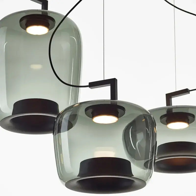 Modern sage green glass pendant lamp set of 3 with frosted glass shades and dark metal fixtures for dining room use