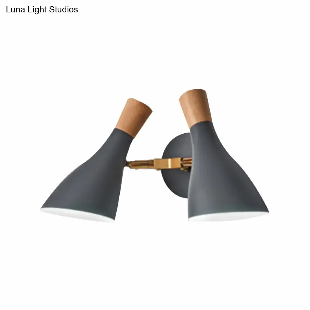 Modern sage green and gray double shade wall sconce with matte gray conical shades natural wood accents and brass arm direct wired