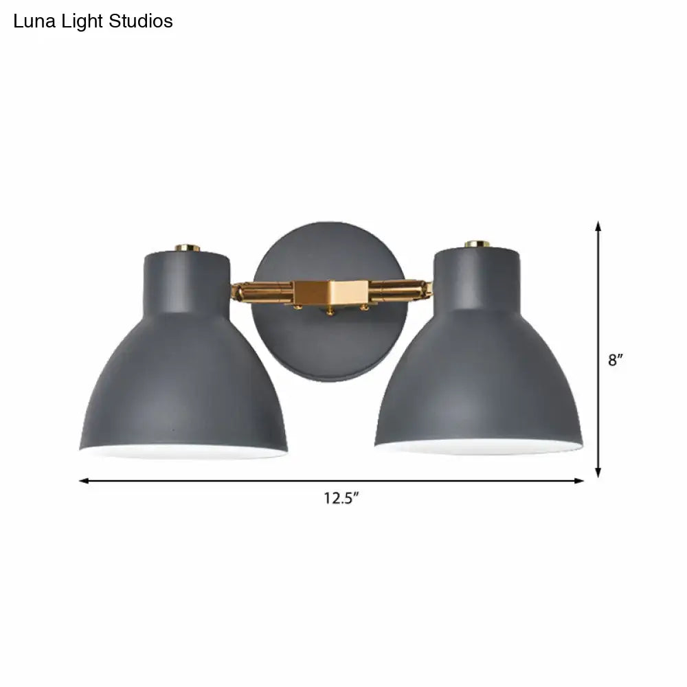 Modern gray and brass double shade wall sconce with two dome-shaped shades, 12 inches high for living room lighting