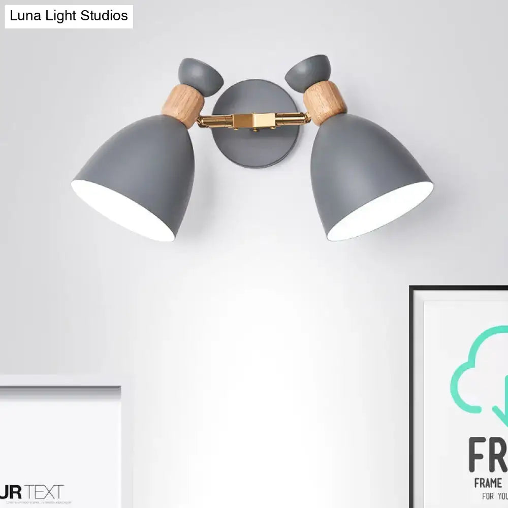 Modern sage green and gray double shade wall sconce with gray matte finish wooden accents and brass hardware inches high