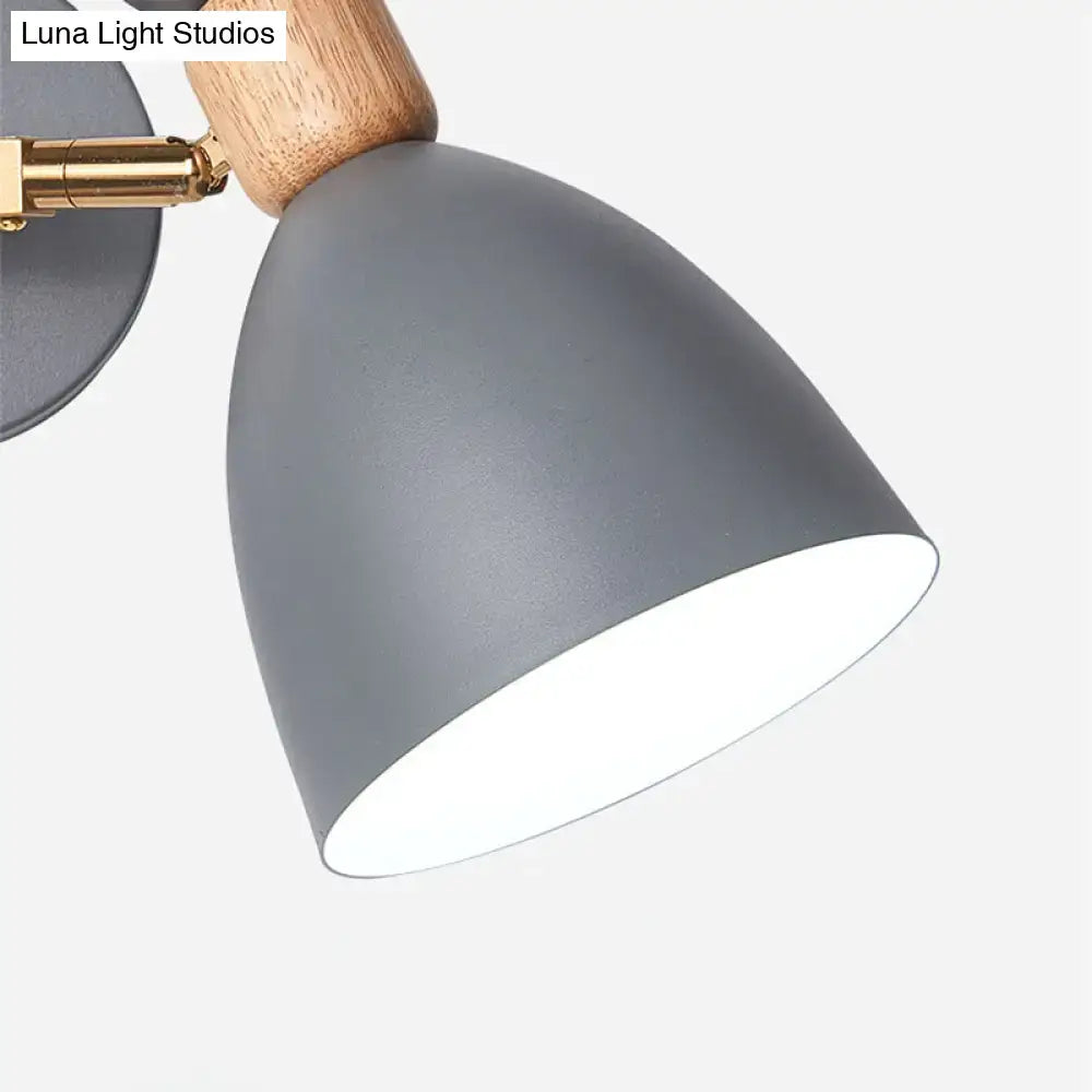 Modern sage green and gray double shade wall sconce with gray matte metal lampshade, wooden handle, and brass hardware