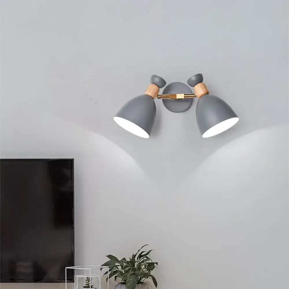 Modern sage green and gray double shade wall sconce with wooden accents and brass hardware direct wired for living room use