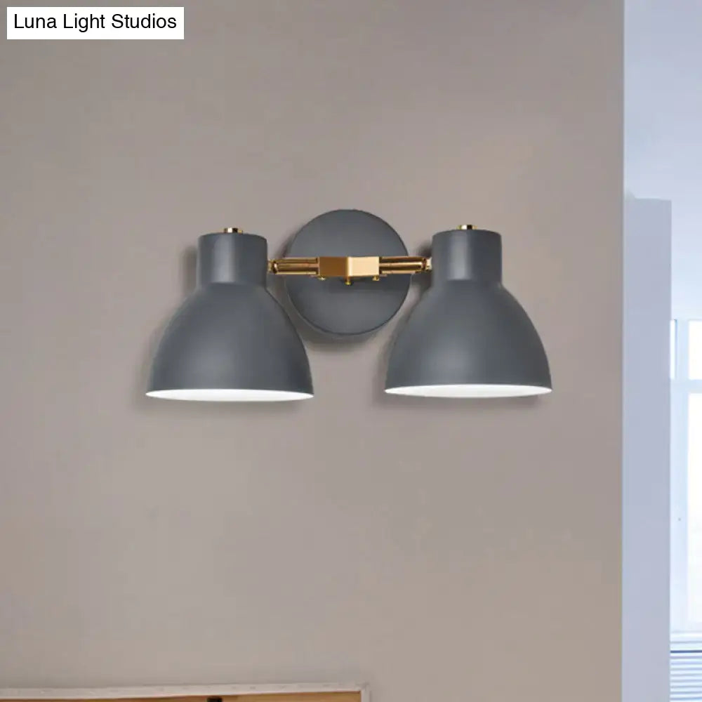 Modern sage green and gray double shade wall sconce with gray metal and brass accents, adjustable arms, 18 inches high