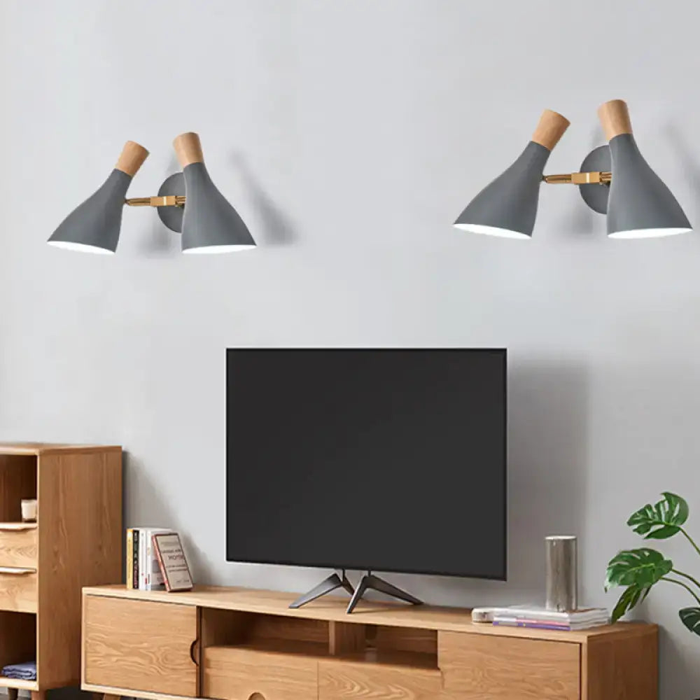 Modern sage green and gray double shade direct wired wall sconce with brass and wooden accents for living room lighting