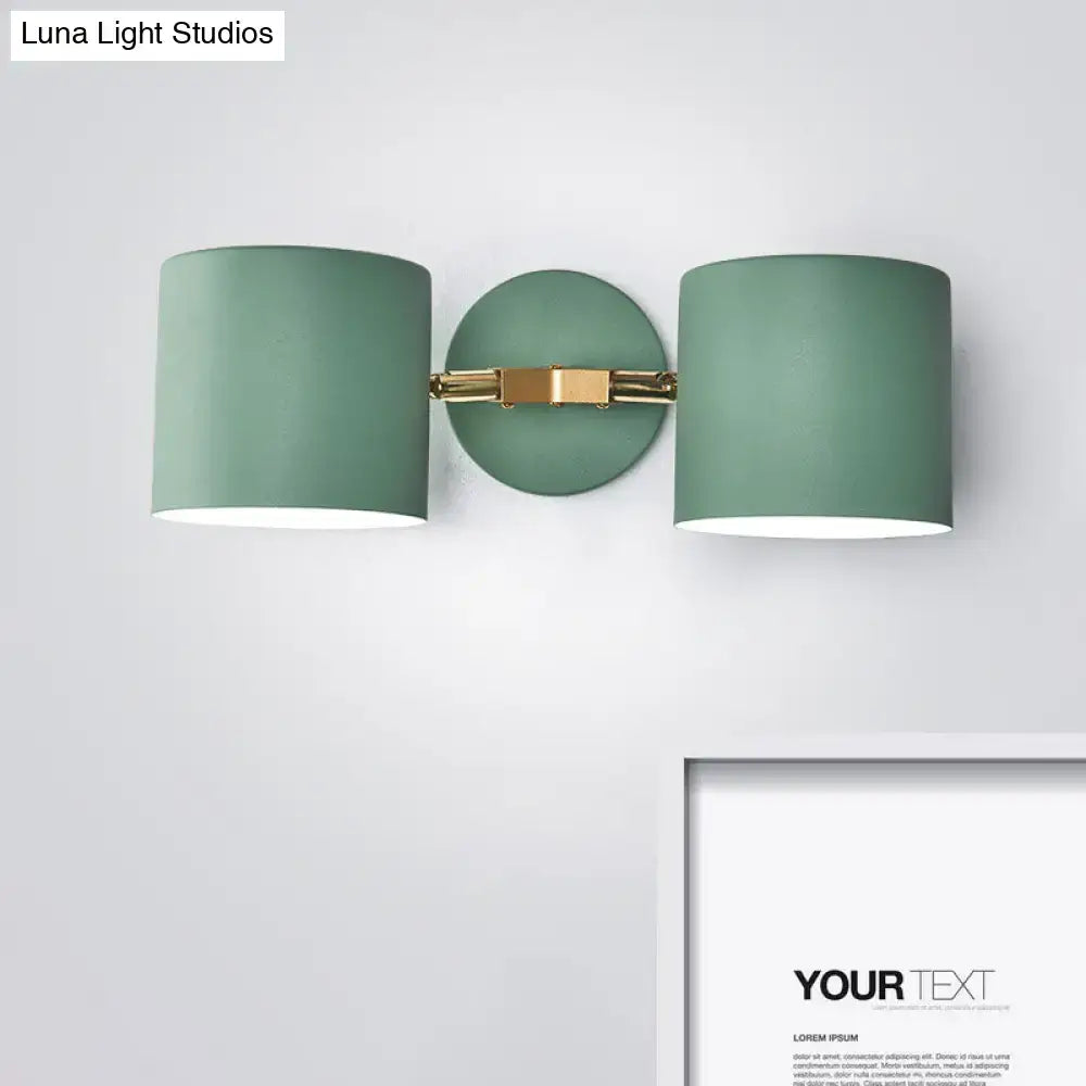 Modern sage green double shade wall sconce with brushed gold bracket, 12 inches high, ideal for living room lighting