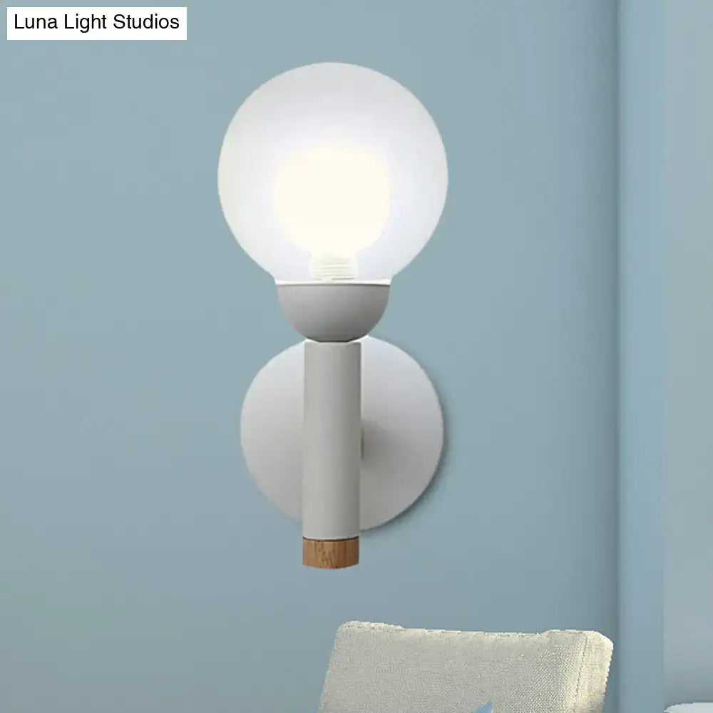 Minimalist modern sage green macaron style torch wall light with frosted glass globe and wooden accent for bedroom