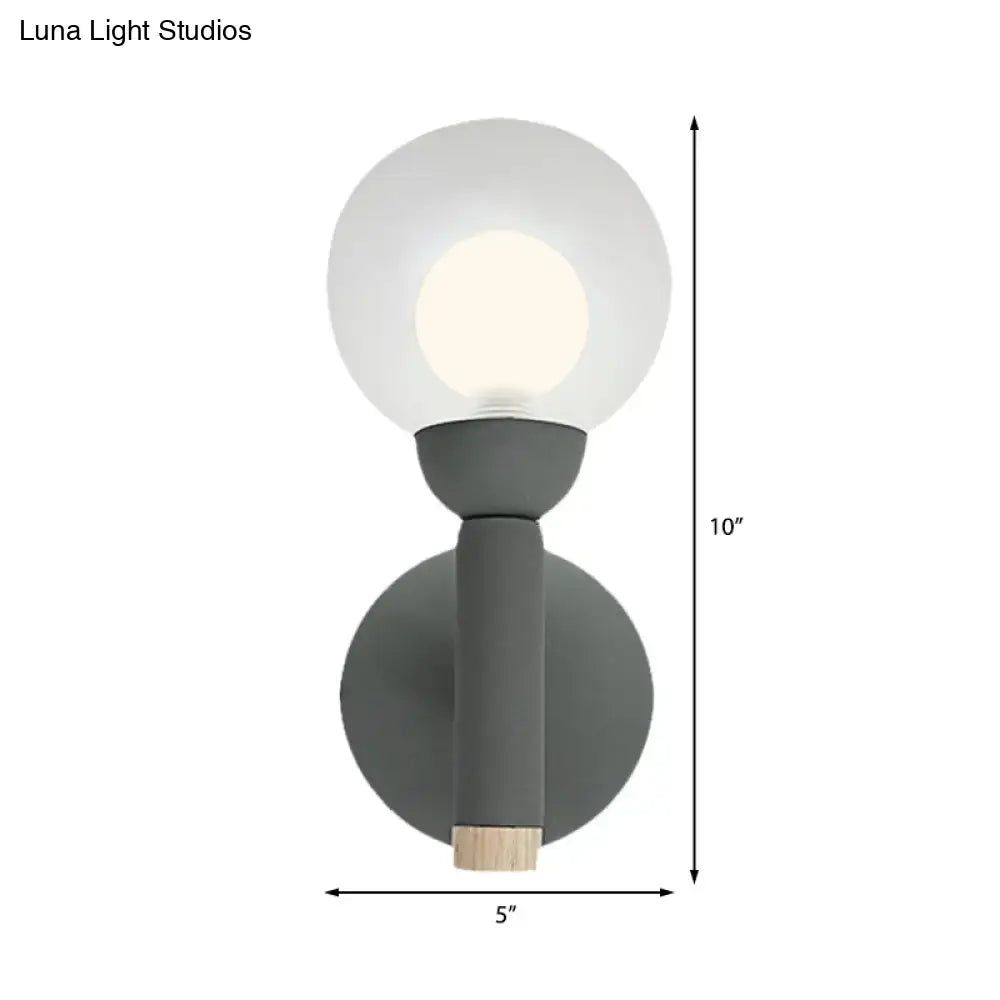 Modern sage green macaron style torch wall light with grey white frosted glass globe and wooden accent for bedroom sconce
