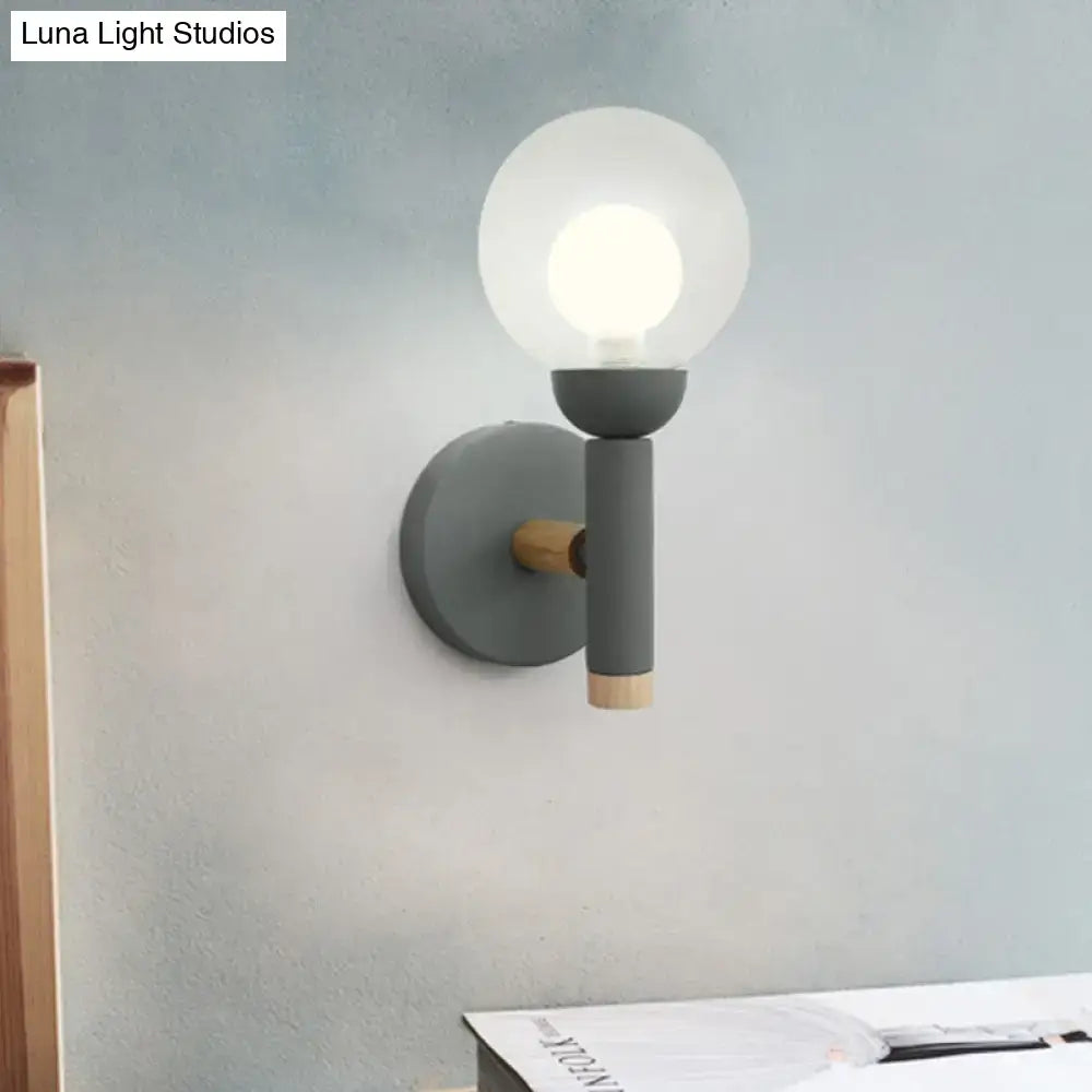 Modern gray wall light with frosted glass globe and wooden accents in macaron style torch design for bedroom use