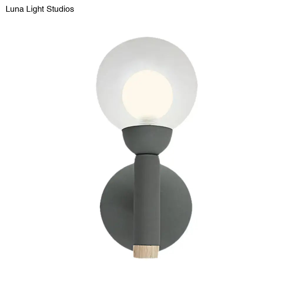 Modern sage green macaron style torch wall light with gray white frosted glass globe and wooden accent for bedroom sconce