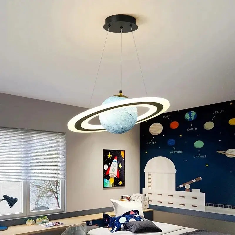 Modern pendant lamp shaped like saturn with textured blue sphere and illuminated bands for boys bedroom star astronaut decor