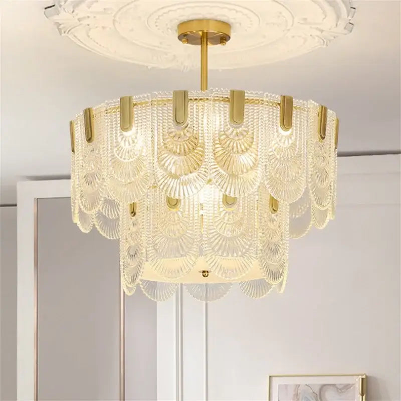 Elegant gold-toned decorbites art glass chandelier with cascading translucent scalloped glass shades for dining room decor