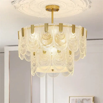 Elegant gold-toned decorbites art glass chandelier with cascading translucent scalloped glass shades for dining room decor