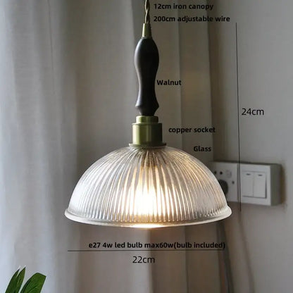 A warm-toned scalloped glass flower led pendant light with brass accents and walnut iron canopy for dining room