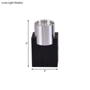 Modern silver aluminum wall light fixture with brushed metal cylindrical holder on black base for bedroom accent lighting