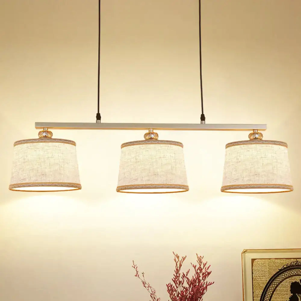 DecorBites modern three-light pendant light with flaxen fabric shades and silver bar for kitchen island lighting