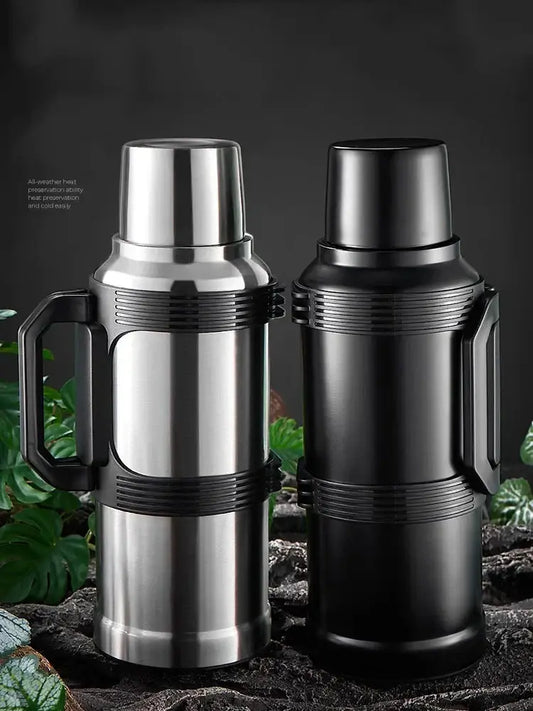 Modern silver and black insulated kettle with glass liner stainless steel thermos featuring textured grip and folding handle