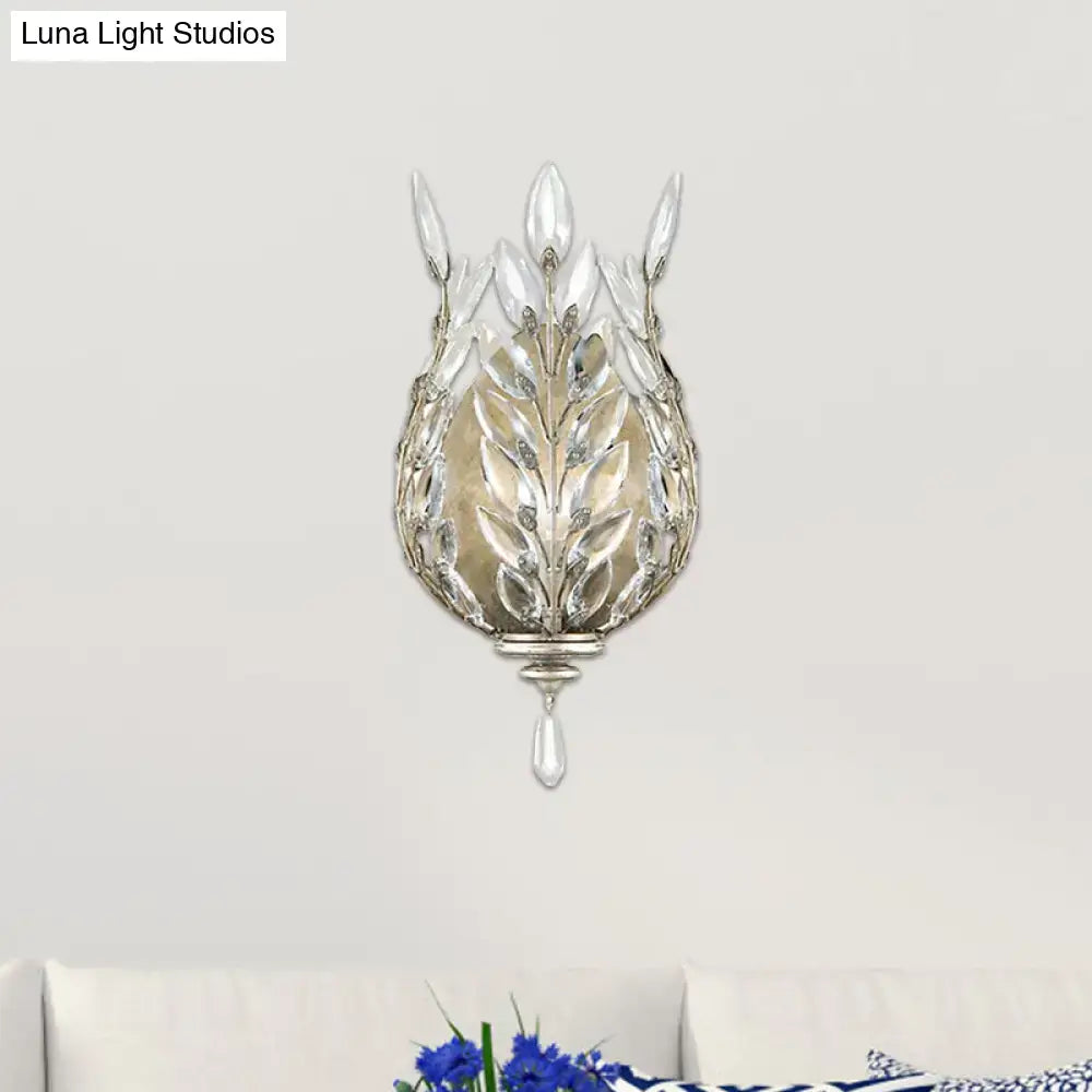 Elegant silver brass wall light with laurel design and crystal drop accent for modern bedroom lighting