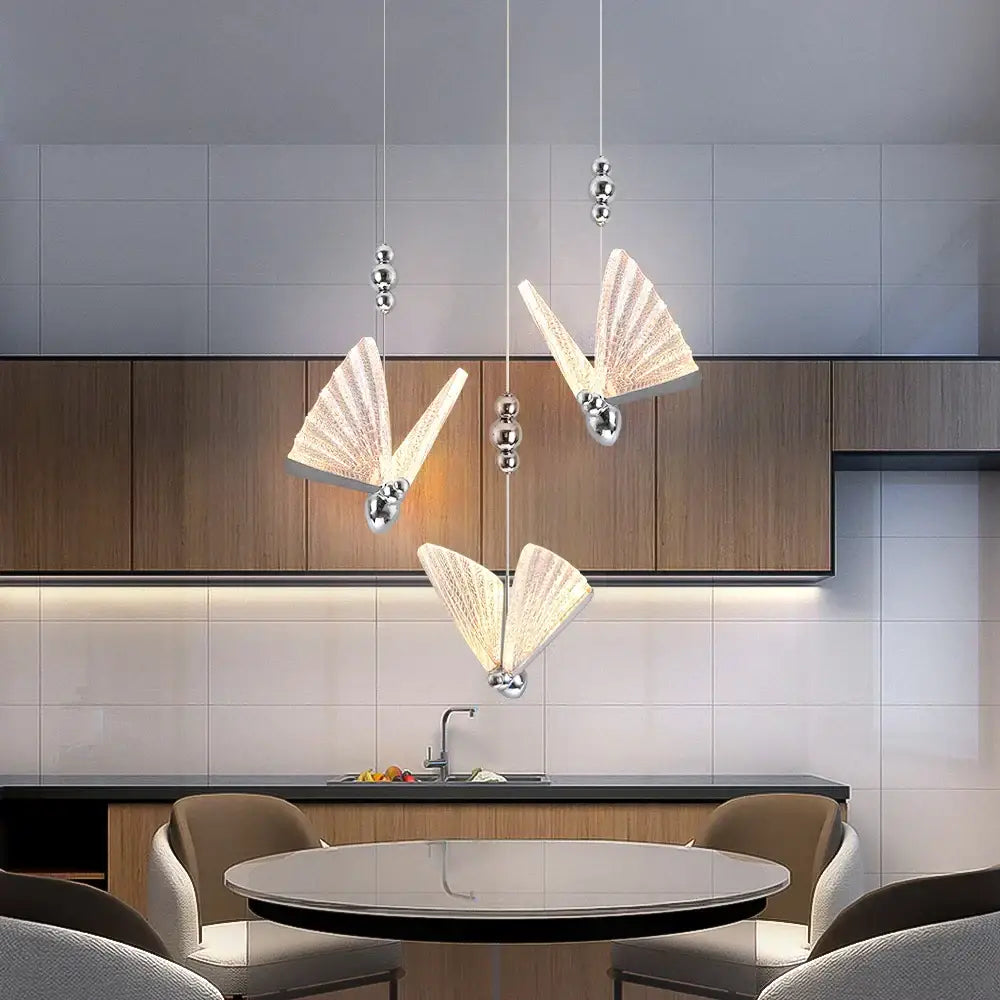 Three elegant modern silver butterfly led pendant lights with translucent ribbed glass wings for living room decorbites