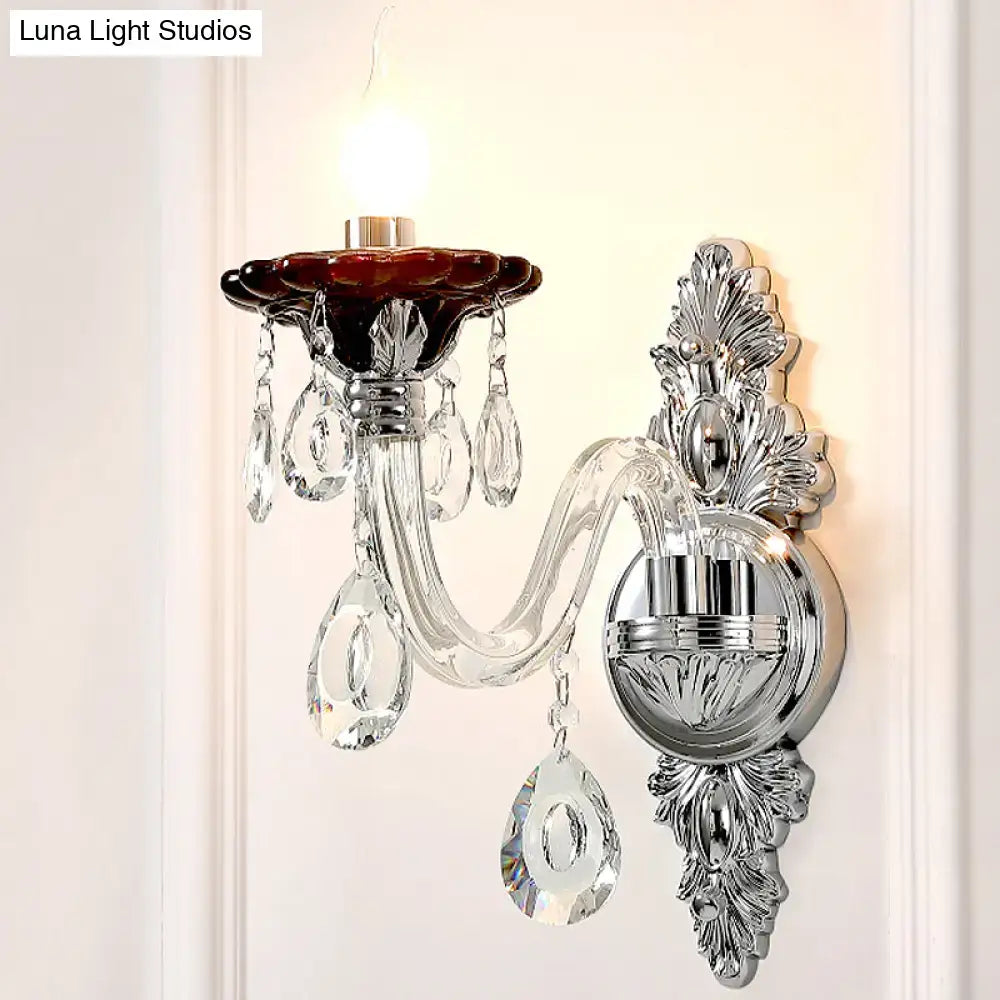 Elegant silver candle wall mounted sconce with chrome finish deep red glass shade and dangling crystal teardrops for bedroom