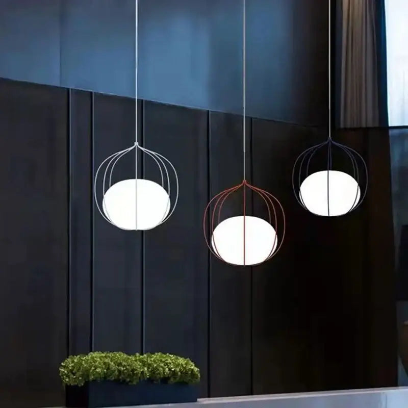 Three modern decorbites birdcage pendant lights with white glass globes in silver and copper finishes for dining room decor