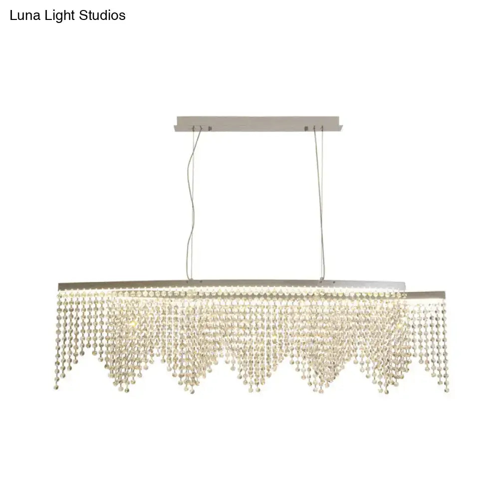 Modern silver crystal island pendant chandelier with sleek metal frame and cascading clear crystal beads for dining room