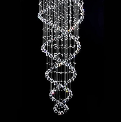 A modern silver decorbites crystal led chandelier with cascading clear faceted beads in spiral tiers for staircase lighting