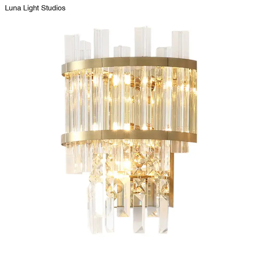 Modern gold-toned wall mounted fixture with cascading clear crystal rods and tiered geometric accents for wall light use